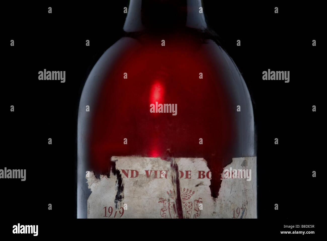 1/2 length study of 1979 Bordeaux red wine bottle. back and side lighting Stock Photo