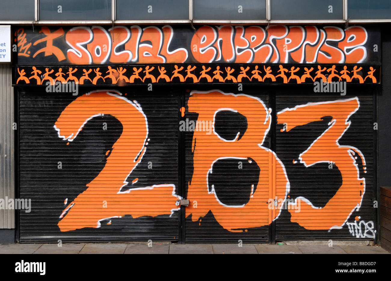 Shop front with painted street number and Social Enterprise sign Stock Photo