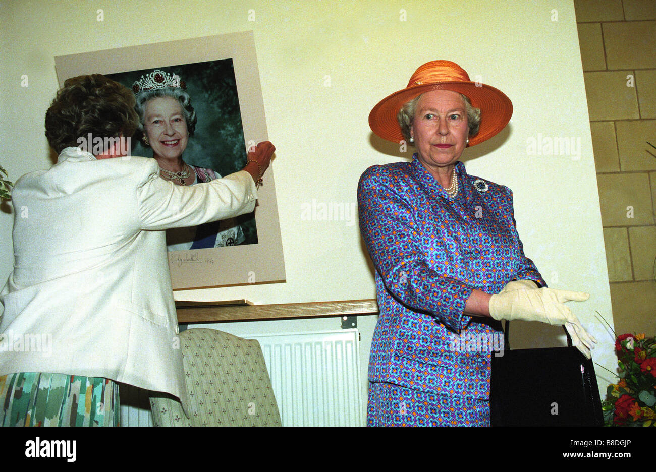 Not Amused The Queen looks away after signing her portrait at Molineux Stock Photo