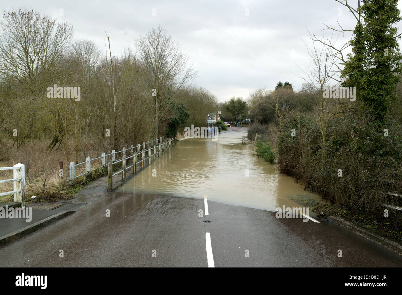 an impassable road due to local flooding with water covering the road or hignway after a river burst its banks Stock Photo