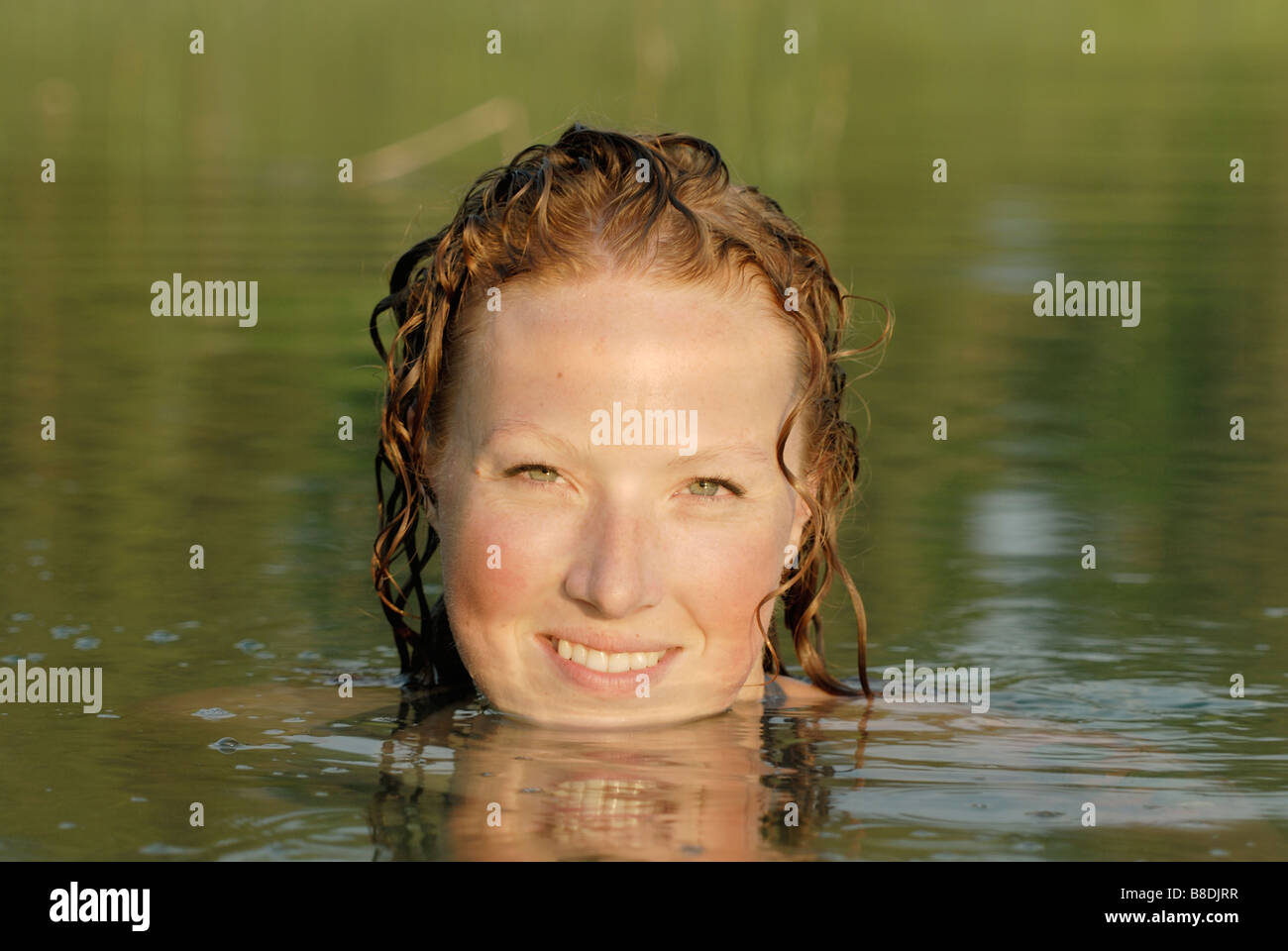 Woman in lake, smiling, Lake Katherine, Riding Mountain National Park, Manitoba, Canada Stock Photo