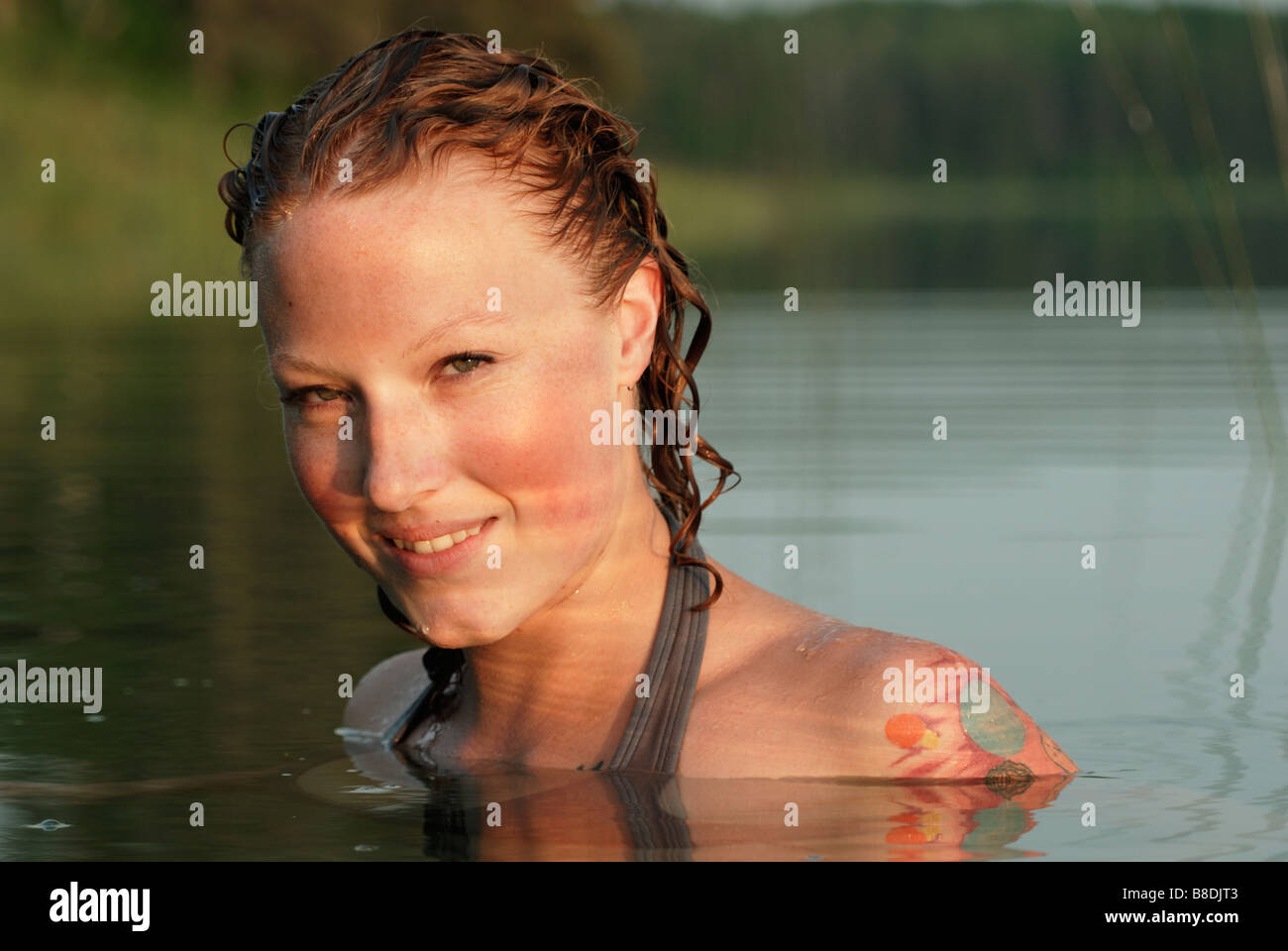 Woman with head and shoulders above water of lake, Lake Katherine, Riding Mountain National Park, Manitoba, Canada Stock Photo