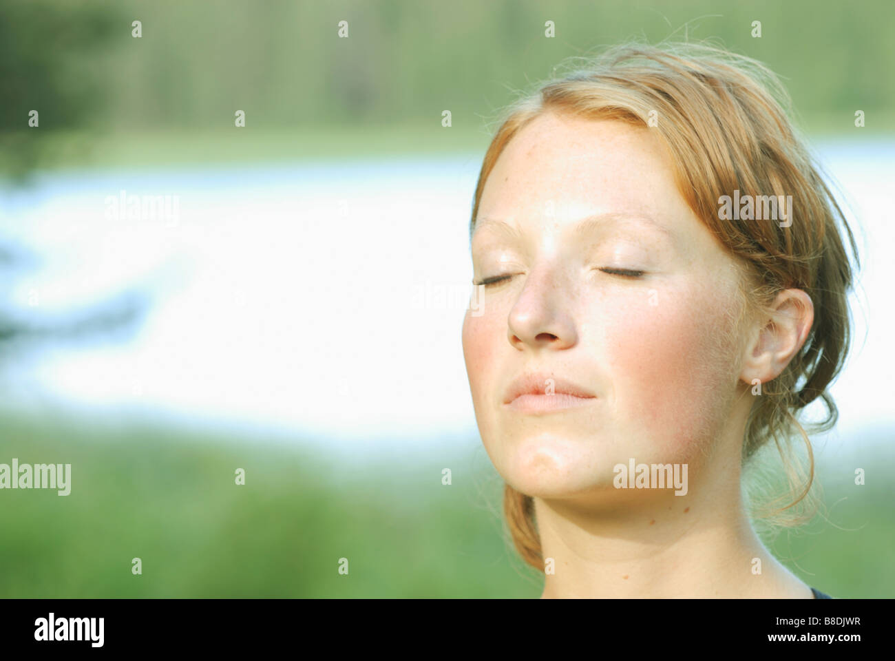 Woman's face with eyes closed, Grayling Lake, Riding Mountain National Park, Manitoba, Canada Stock Photo