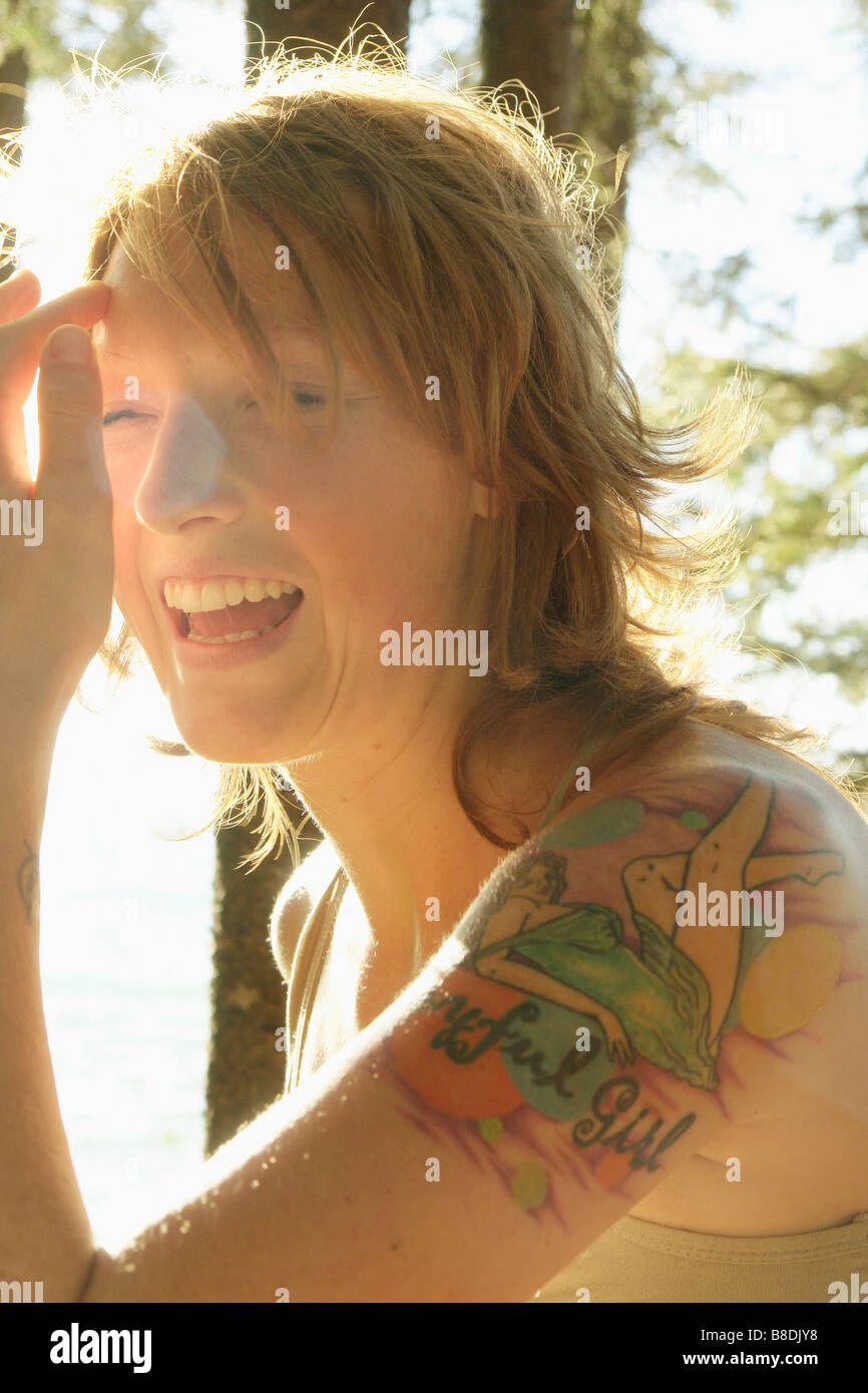 Profile of woman laughing outdoors, Riding Mountain National Park, Manitoba, Canada Stock Photo