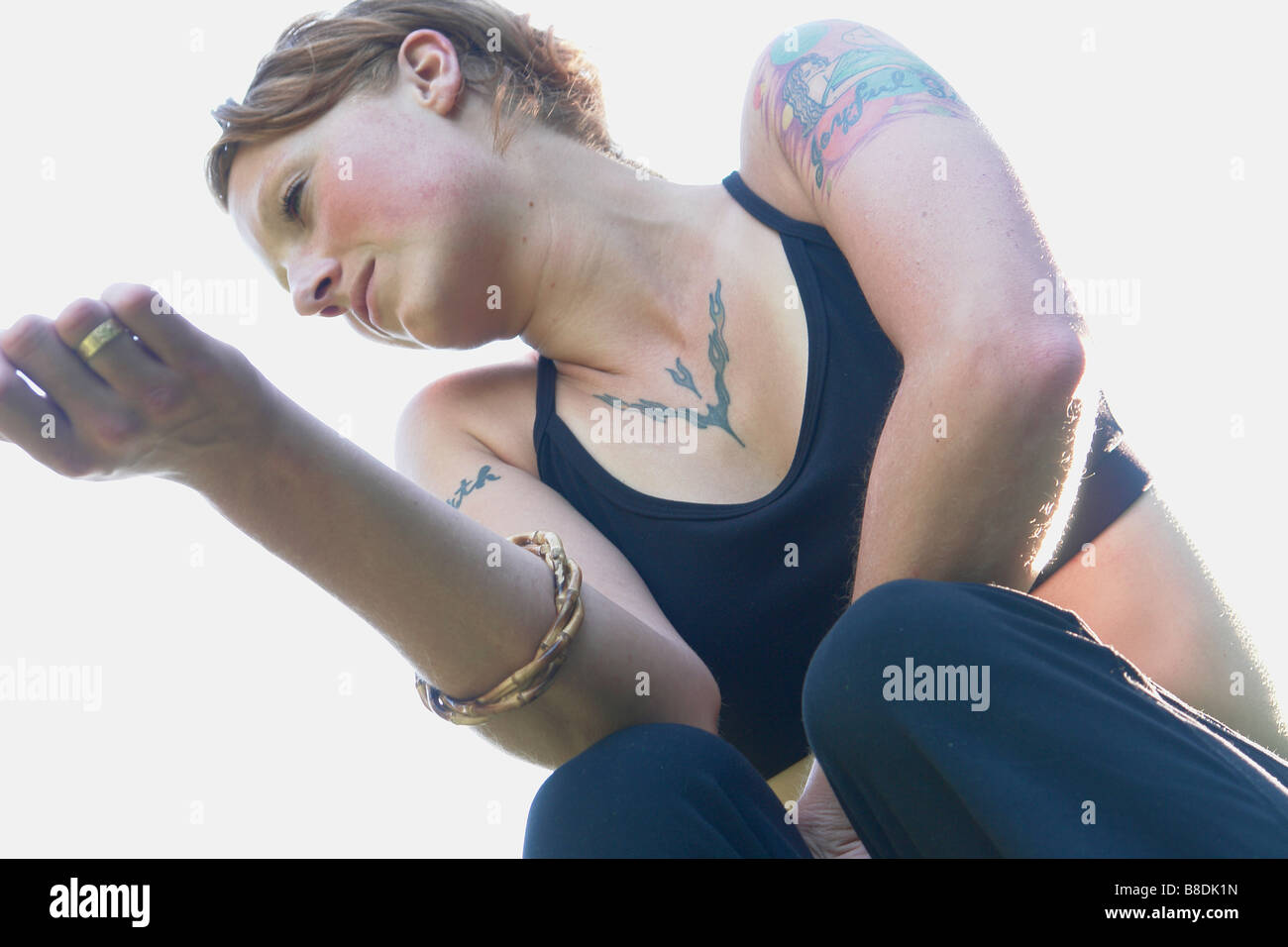 Low angle portrait of woman with tattoos Stock Photo