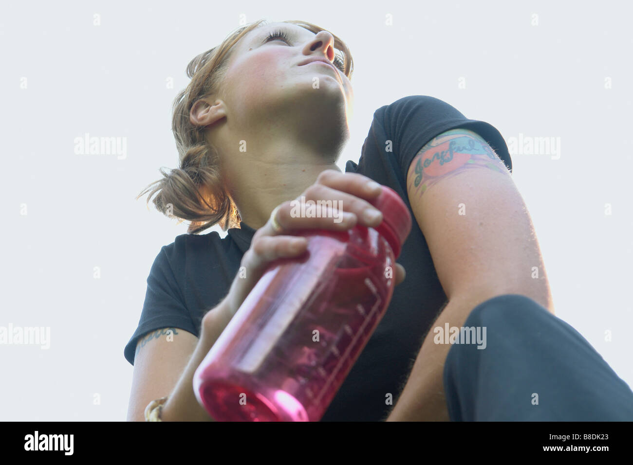 Low angle portrait of woman with re-useable water bottle Stock Photo