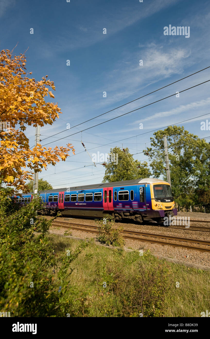 Class 365 train in First Capital Connect livery speeding along the