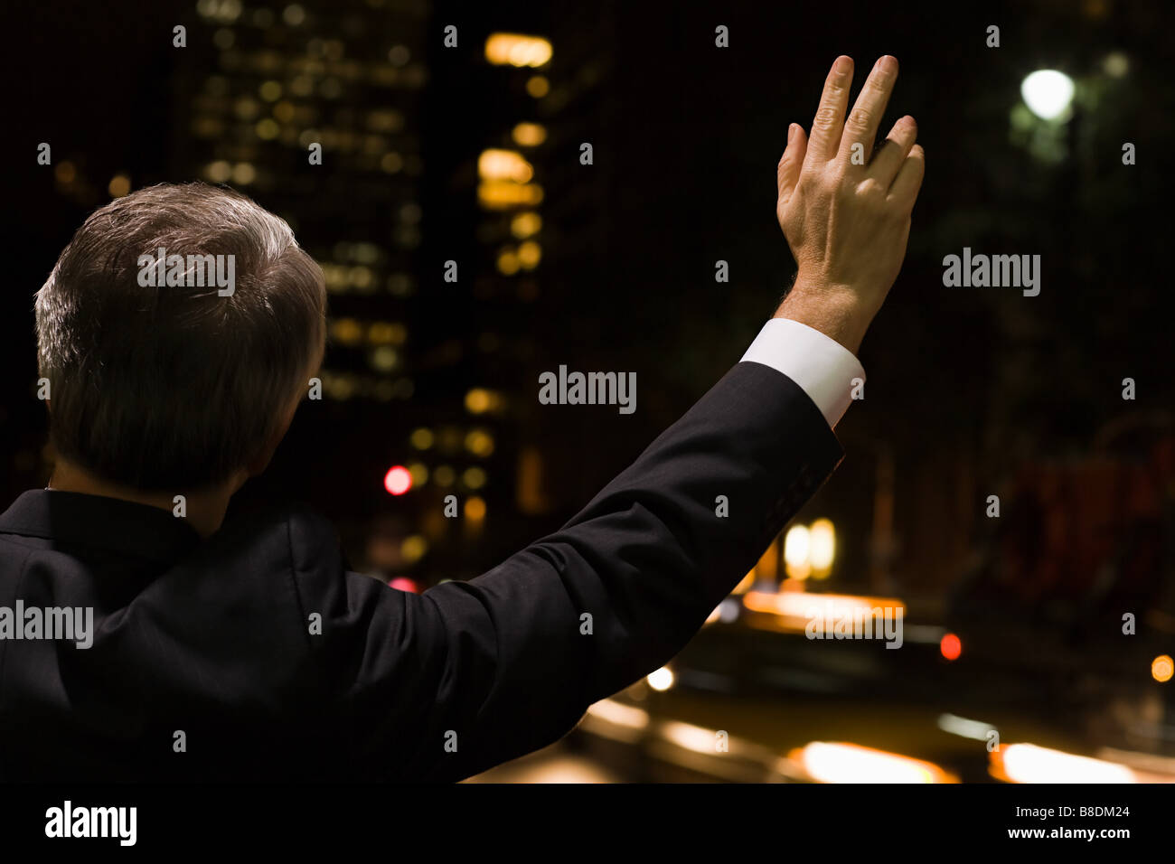 Businessman hailing a cab Stock Photo