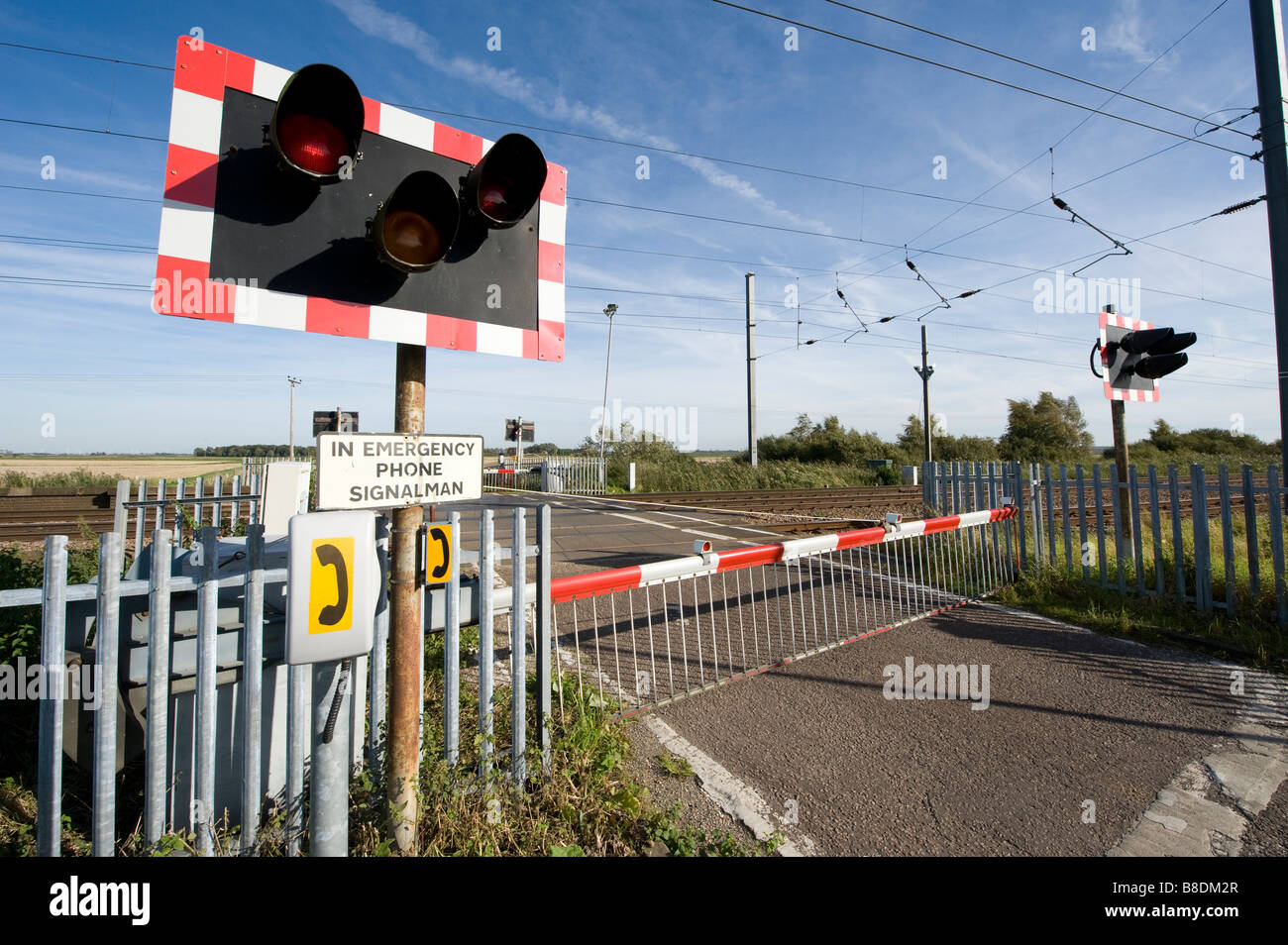 Level Crossing With Warning Lights Flashing And Barriers Down On The East Coast Main Line Railway In The Uk Stock Photo Alamy