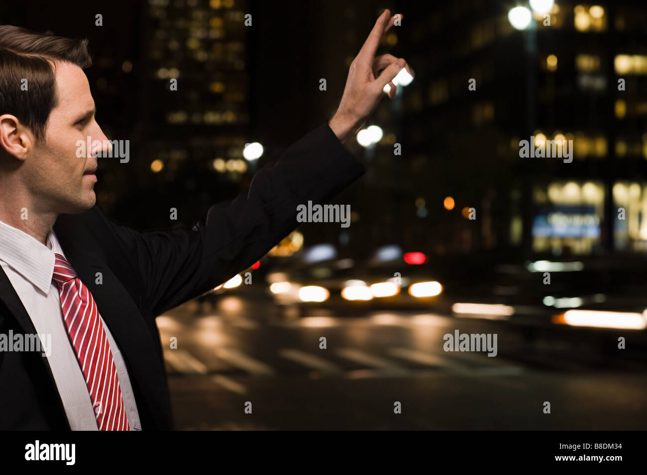 Businessman hailing a cab Stock Photo