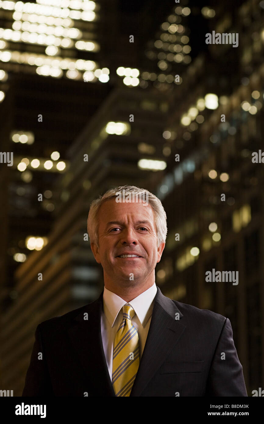 Smiling businessman at night Stock Photo - Alamy