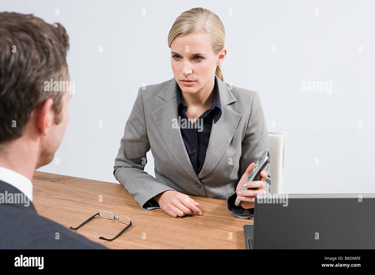 Businesswoman with remote control Stock Photo