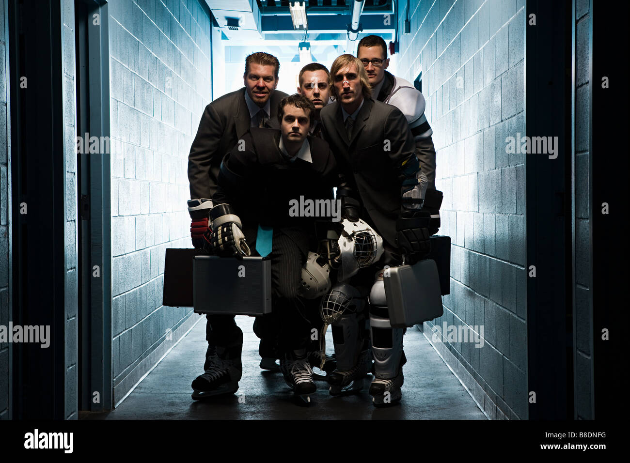 Five businessmen wearing ice hockey uniforms Stock Photo