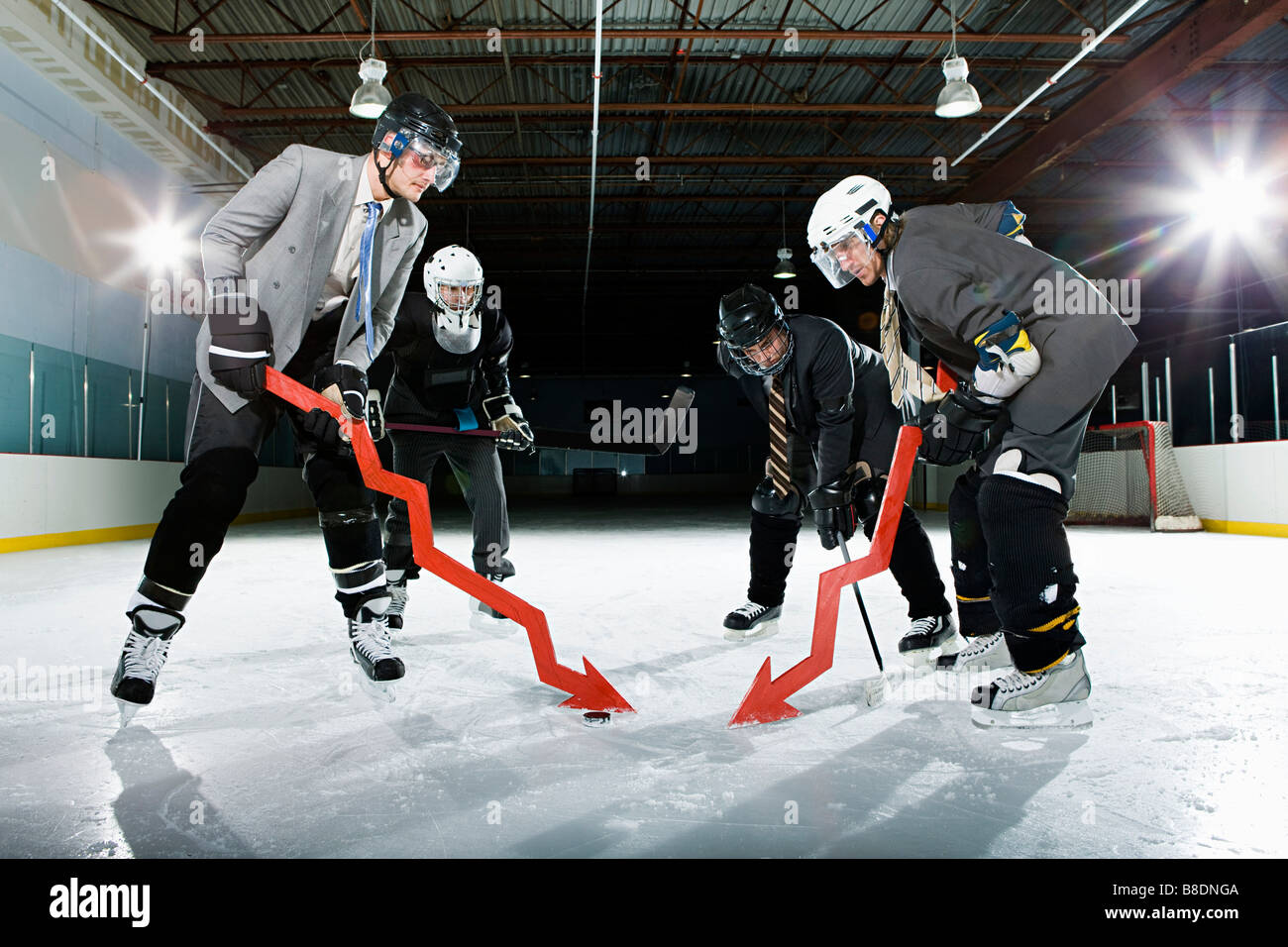 Businessmen playing ice hockey Stock Photo