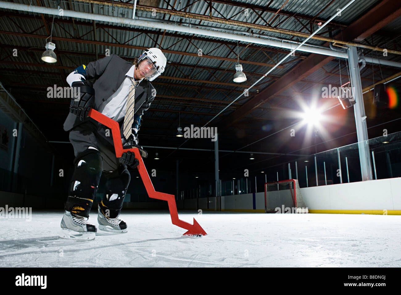 Businessman playing ice hockey Stock Photo