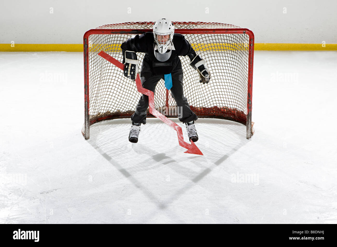 Businessman playing ice hockey Stock Photo