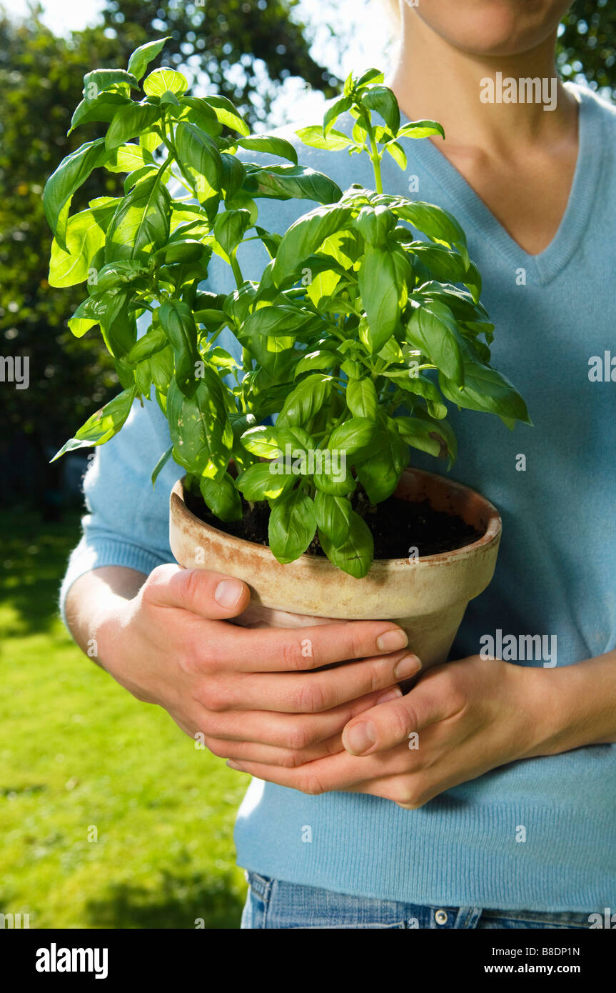 Woman holding a plant Stock Photo