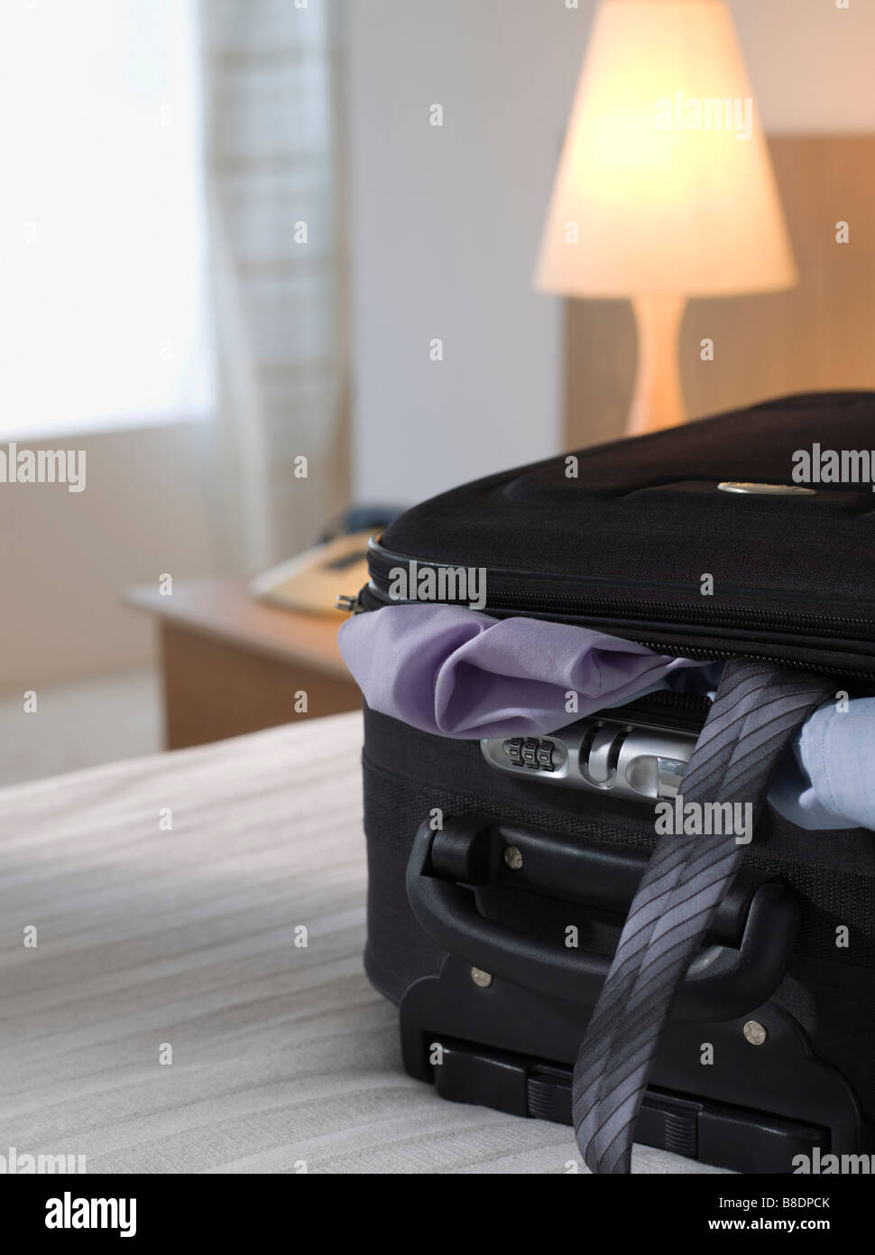 Full suitcase in a hotel room Stock Photo