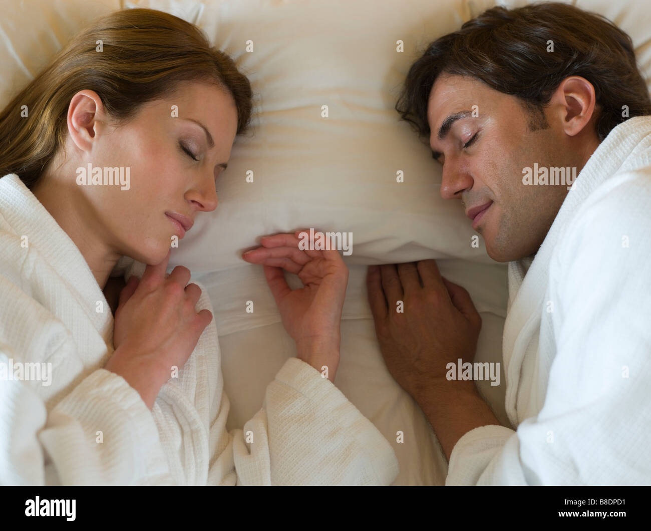 Couple sleeping in bed Stock Photo - Alamy