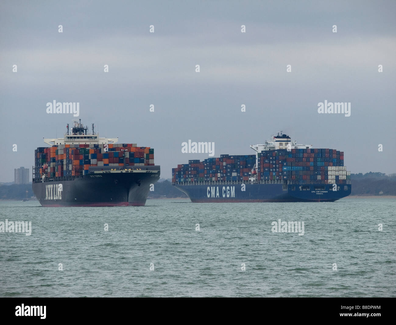 Container ships NYK Terra (left) and CMA CGM Carmen passing each other in Southampton Water UK Stock Photo