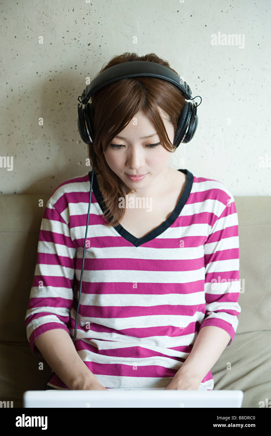 Asian woman in headphones sitting hi-res stock photography and images ...