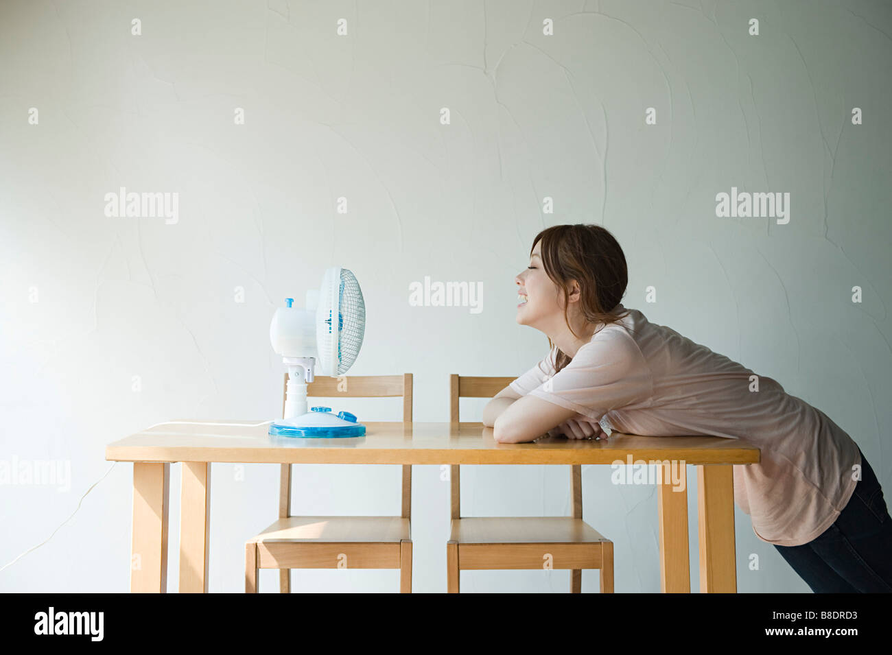 Young woman with fan Stock Photo - Alamy