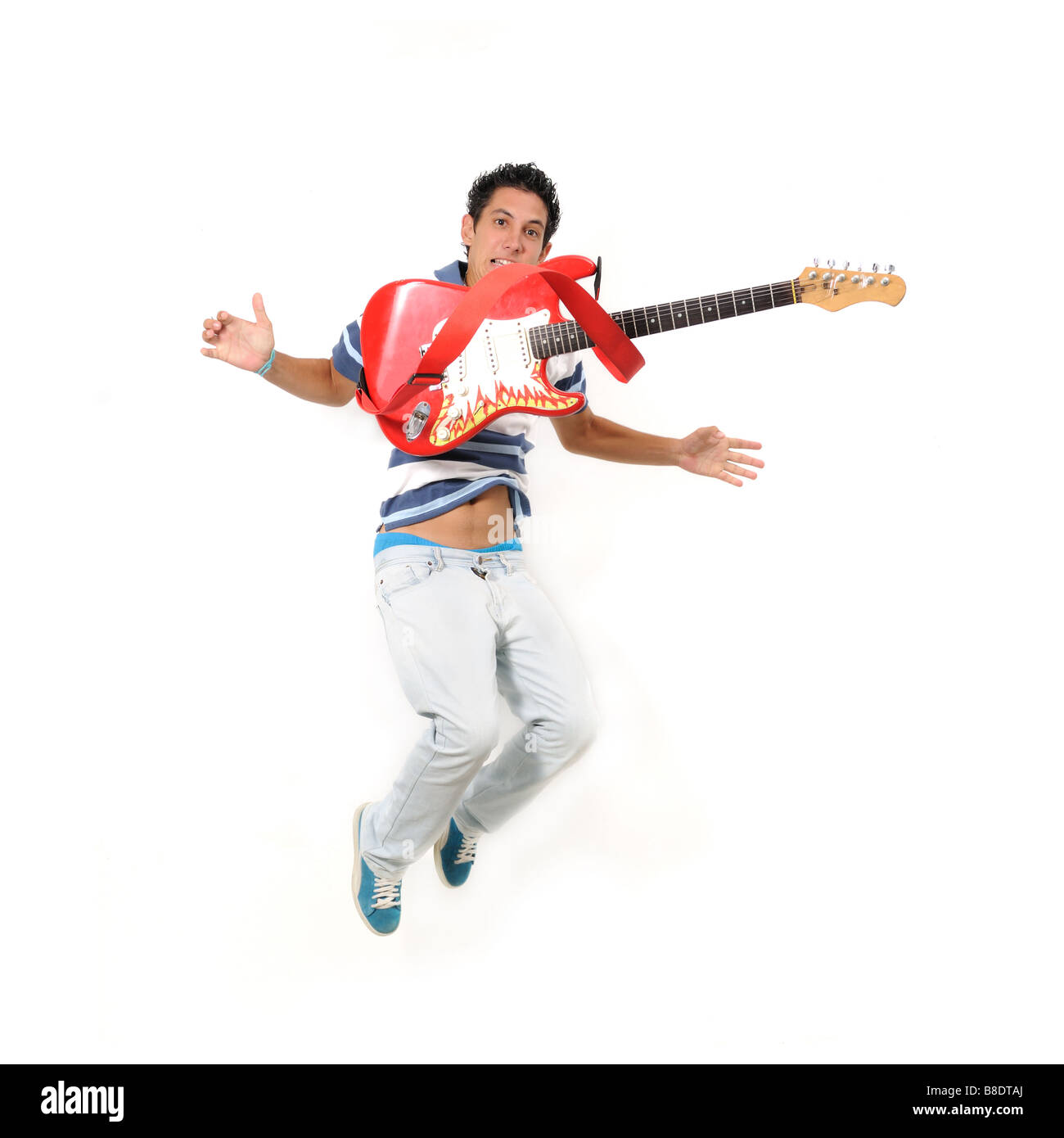 Portrait of trendy teen boy jumping with electric guitar - isolated Stock Photo