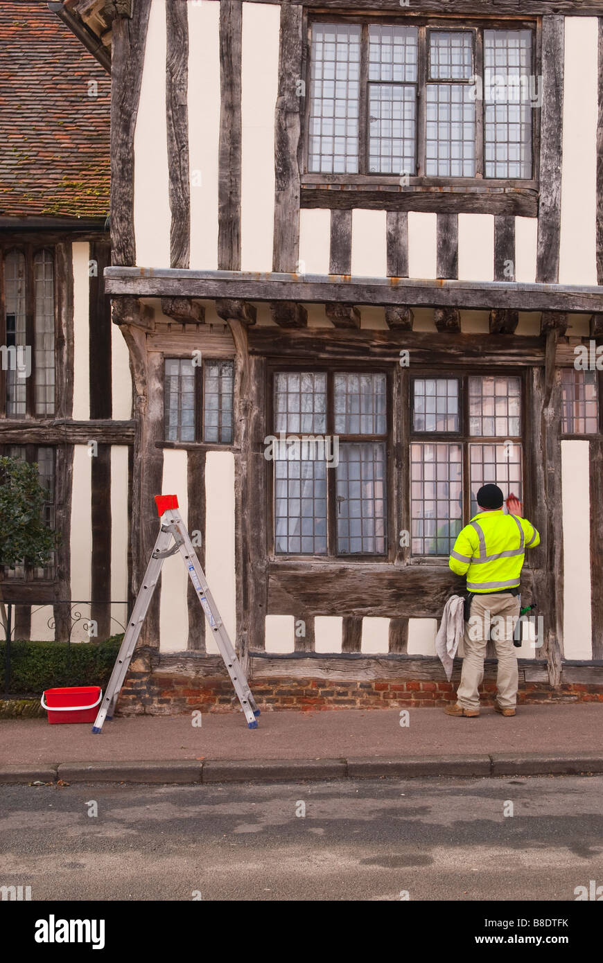 Man On Ladder Cleaning Windows High Resolution Stock Photography and