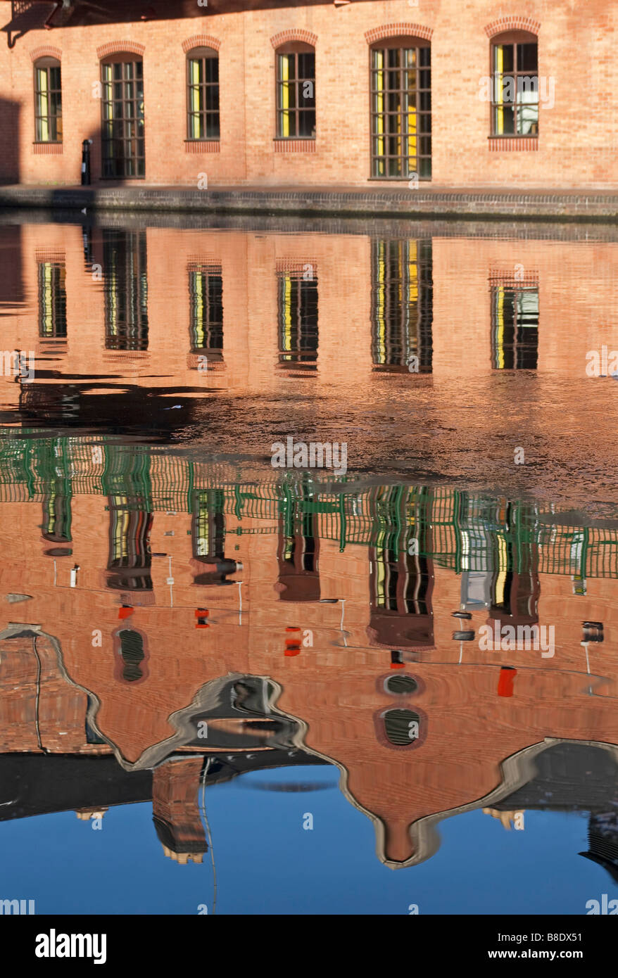 Reflections of canalside buildings in the canal at Sherborne Street Wharf Birmingham Stock Photo