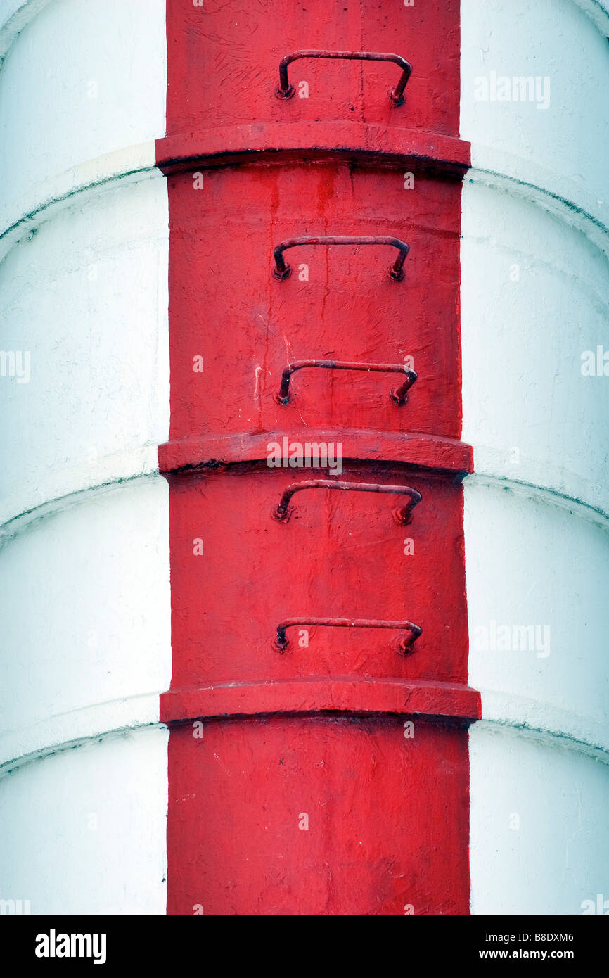Old soviet lighthouse tower detail with fixes metal ladder on it wall. Stock Photo