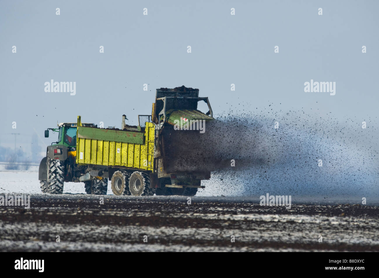 agricultural vehicle spray spraying out compost farming farm field agriculture rural economy cultivation system lime liming dung Stock Photo