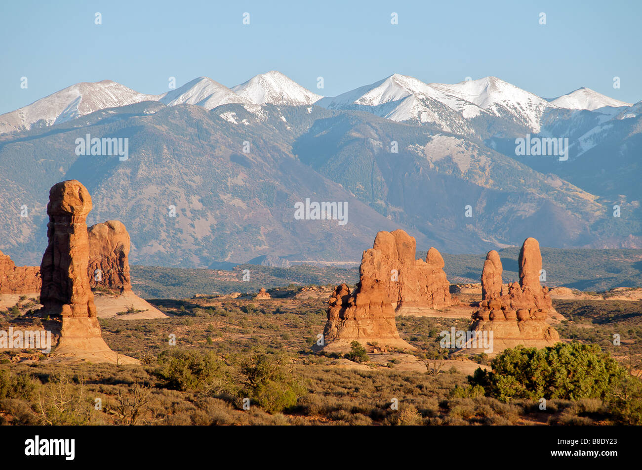 Panoramic view with backdrop of snow capped mountains Arches National Park Utah USA Stock Photo