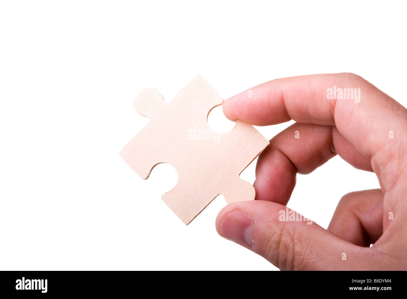 hand holding a piece of a puzzle isolated on white Stock Photo - Alamy