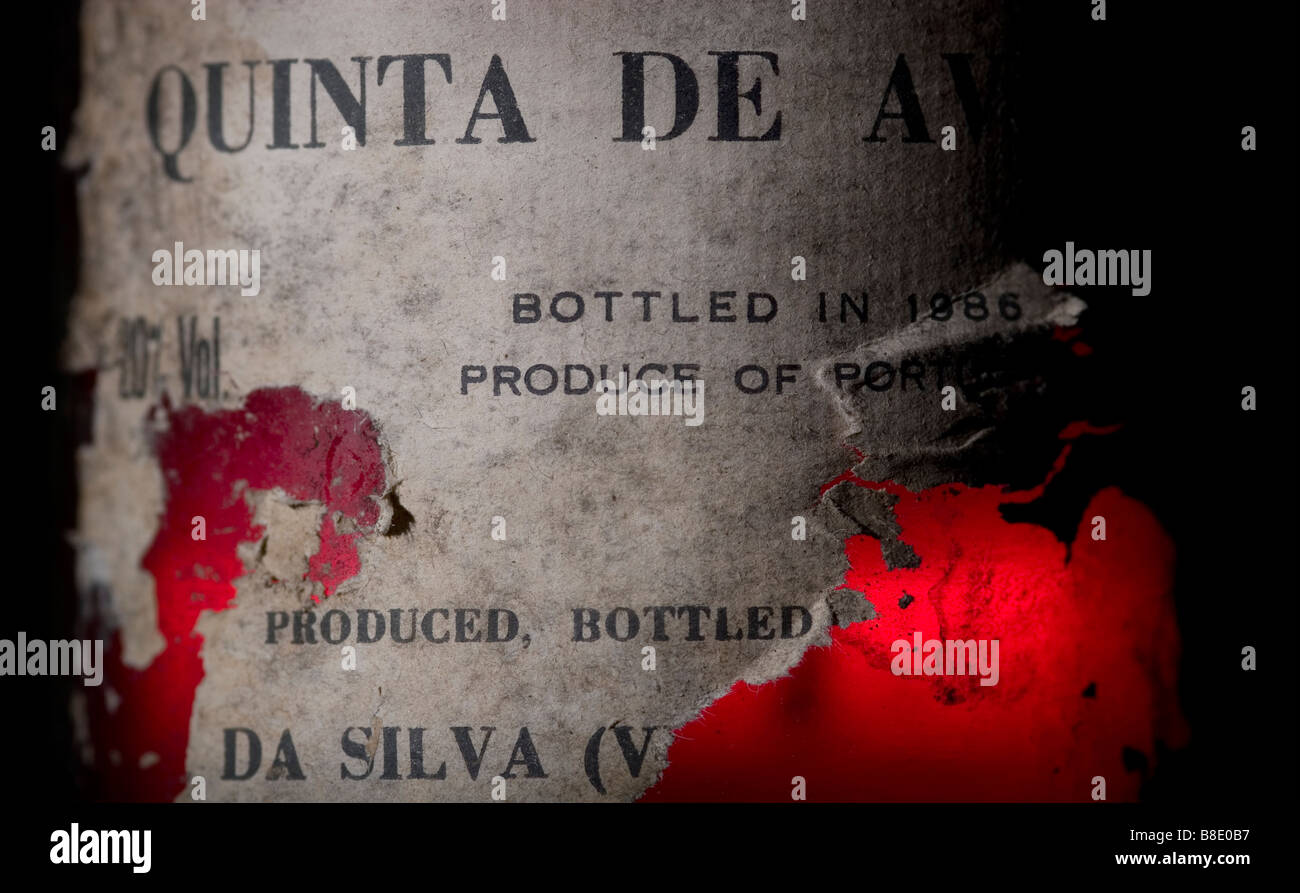 old port bottle ,backlit with torn/damaged label Stock Photo Alamy
