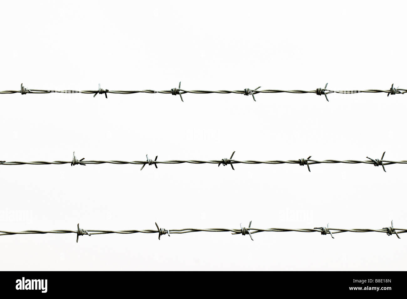 Three strands of barbed wire. Stock Photo