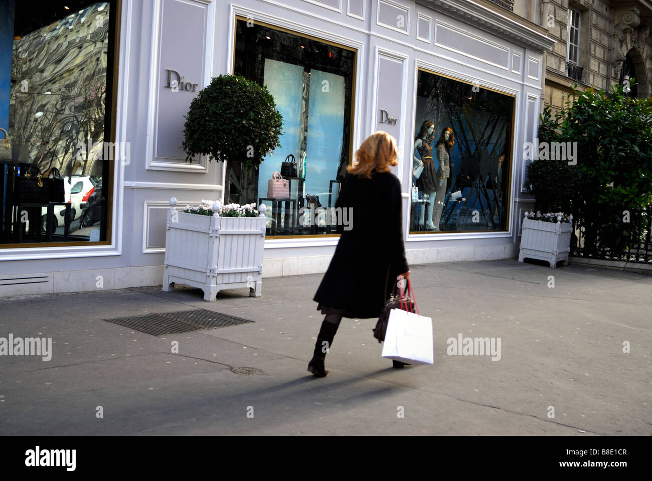 Paris, France, Luxury Shopping Street Scene Boutique Woman With Shopping Bags Walking by Christian Dior Store Shop Front WIndow, mode labels, fashion, Stock Photo