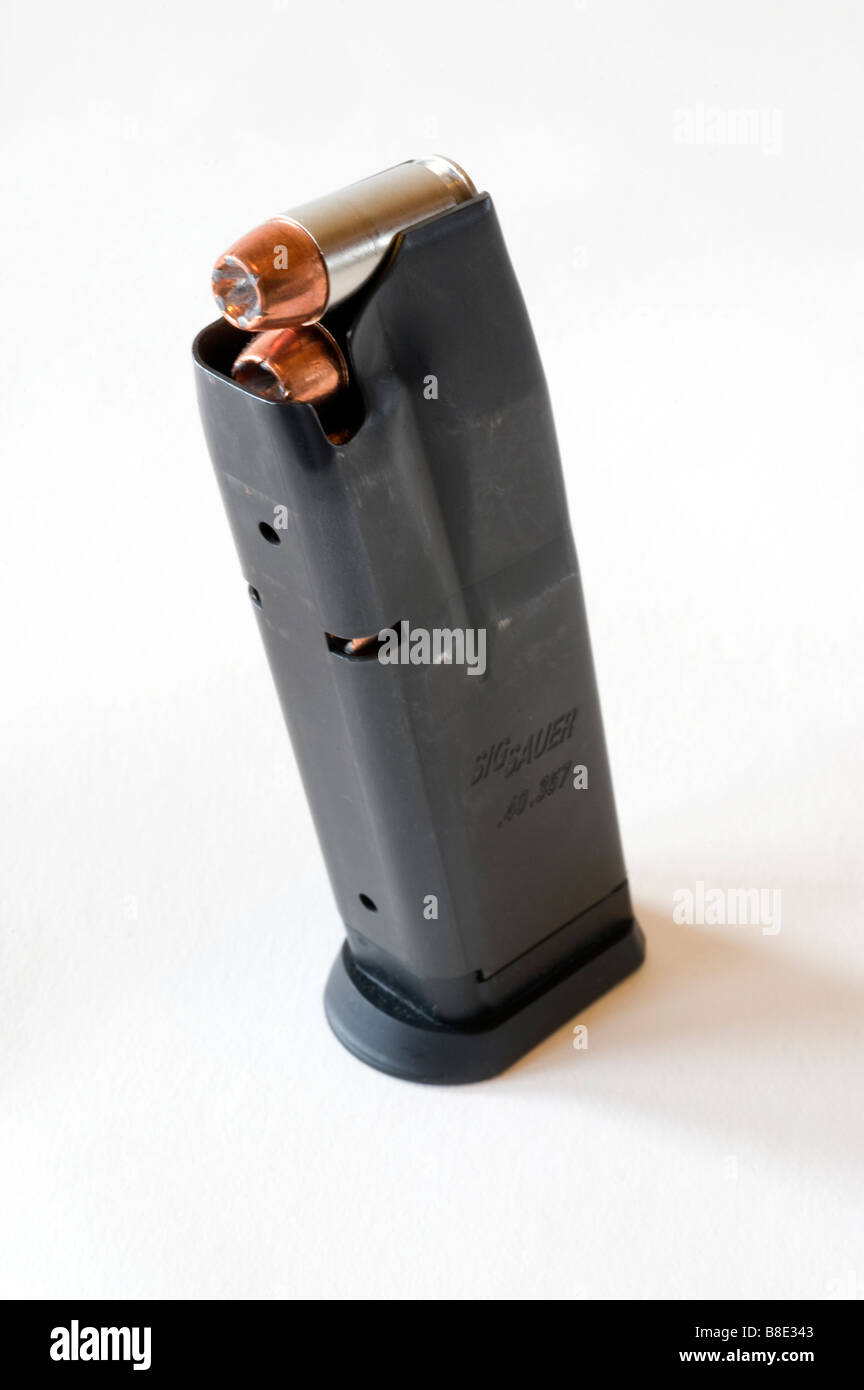 Silhouetted Sig Sauer 229 .40 caliber magazine loaded with speer gold dot hollowpoints against a white background Stock Photo