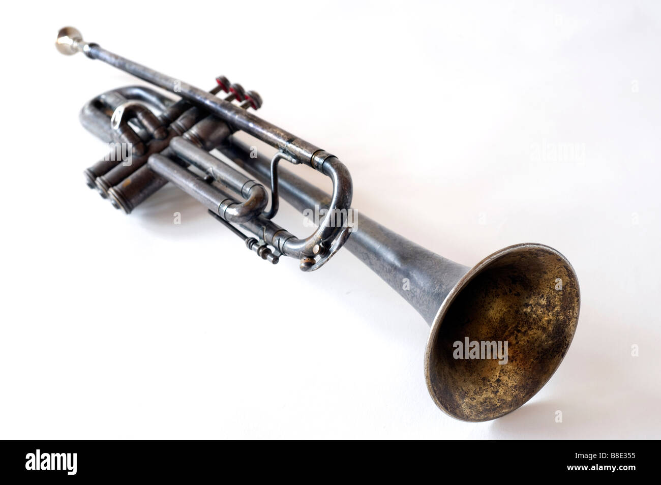 Silhouette image of an old tarnished trumpet on white seamless background. Stock Photo