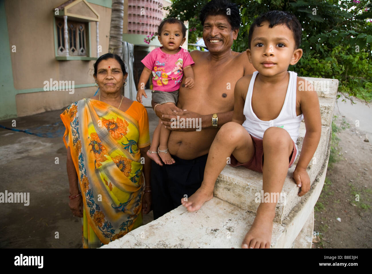 Indian grandparents with two grandchildren (thought to be grandson and granddaughter). Hazira, Surat, Gujarat. India. Stock Photo