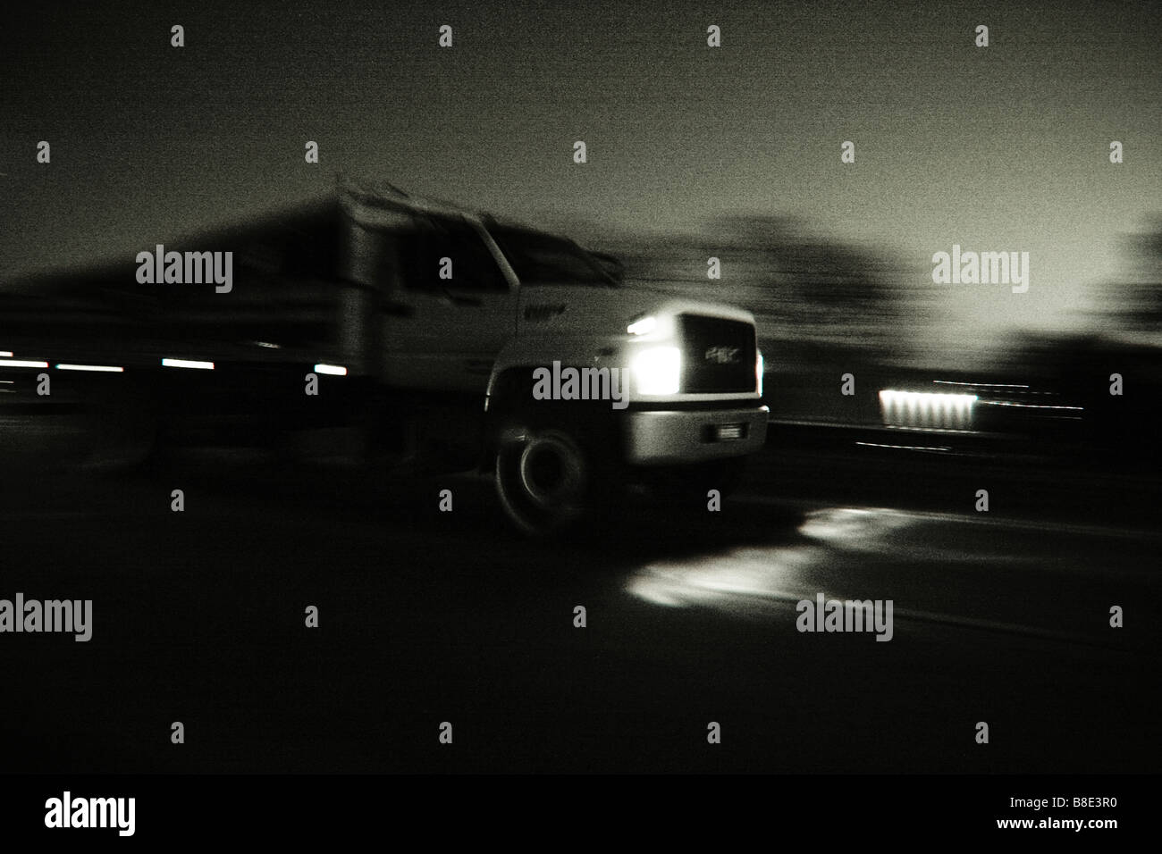 panning of truck at dusk in Black and White. Stock Photo