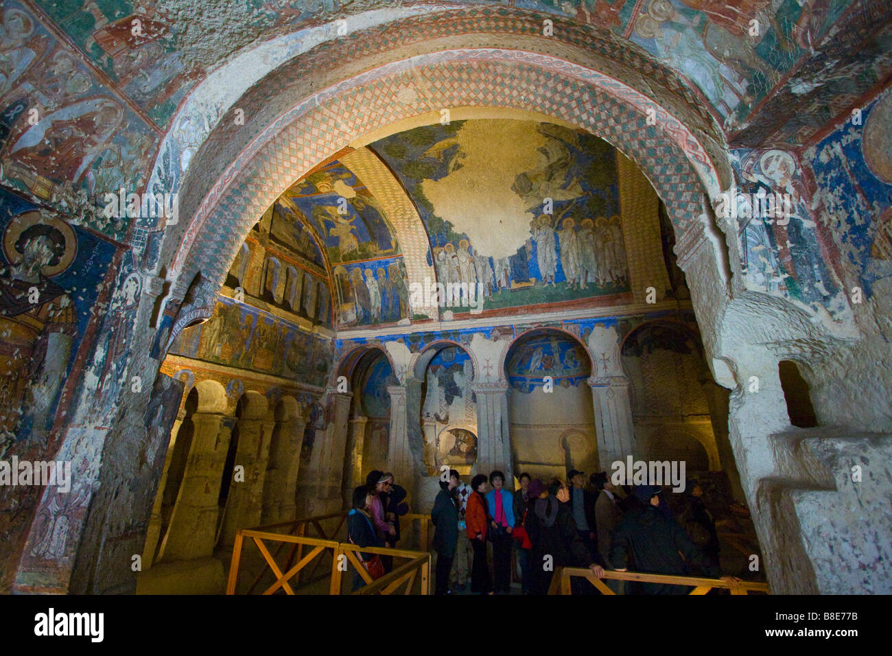 South Korean tour group looking at Frescos in the Buckle Church or Tokali Kilise in Goreme Open Air Museum in Cappadocia, Turkey Stock Photo