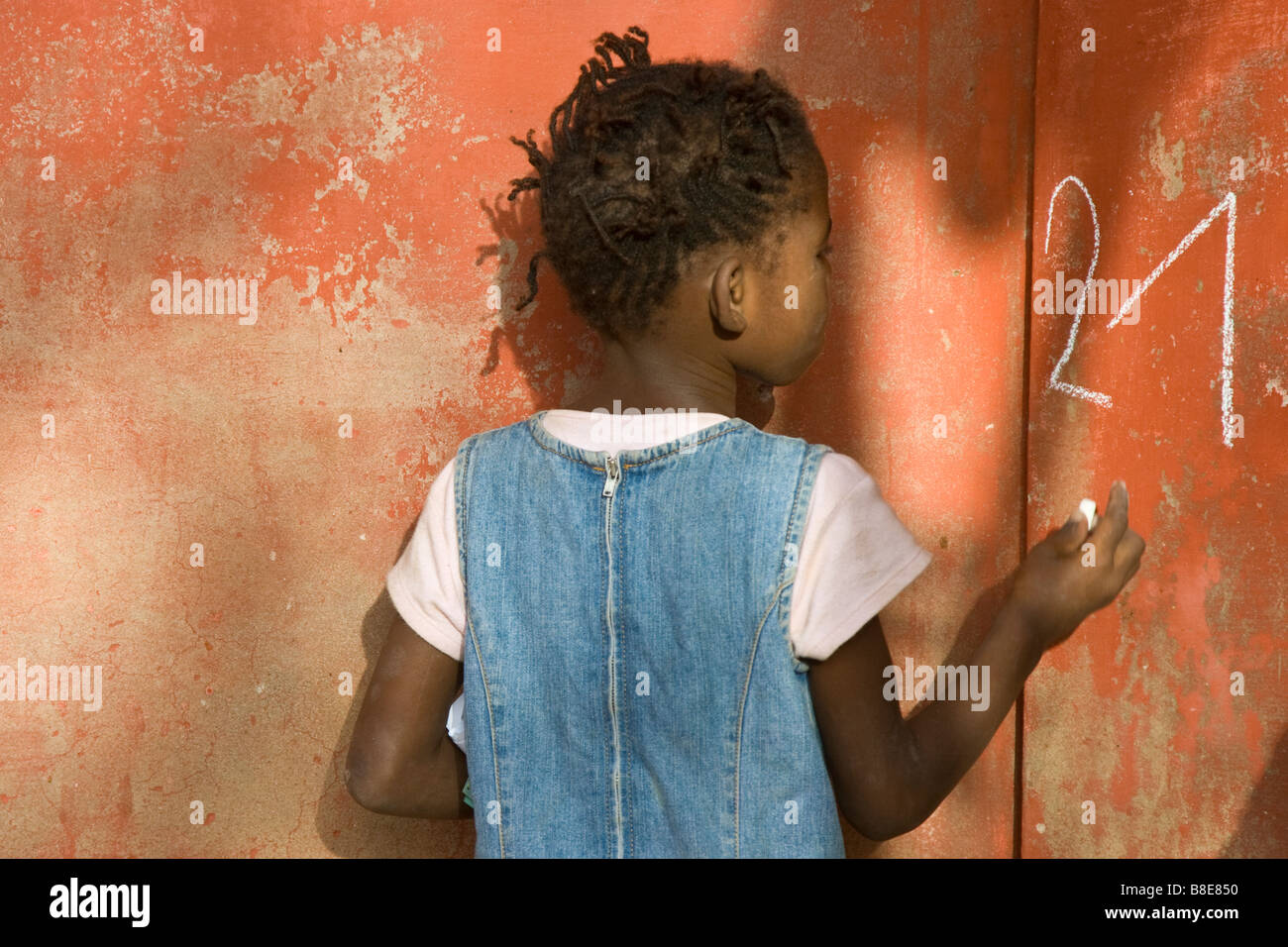 Senegalese Girl Writing on a Wall with Chalk on Ile de Goree in Senegal West Africa Stock Photo