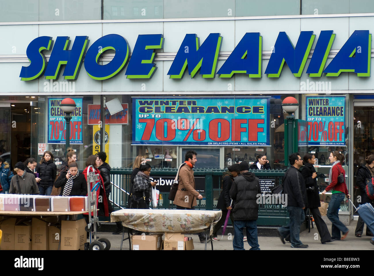Shoppers pass a Shoe Mania store advertising it s sales in Union Square in  New York Stock Photo - Alamy