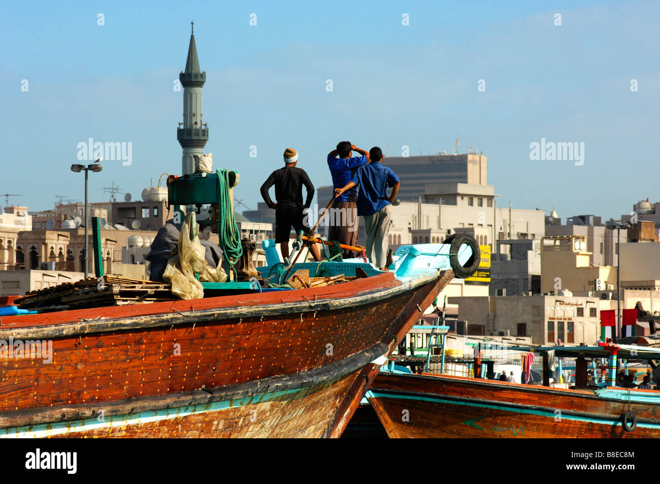 Dhow crew watching the arrival in the port of the Dubai Creek, Dubai, United Arab Emirates Stock Photo