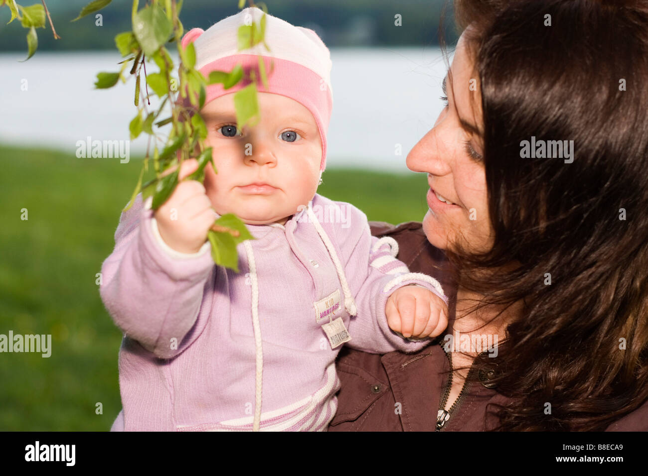 Mother 32 years old and her baby girl 9 months old outside Stock Photo