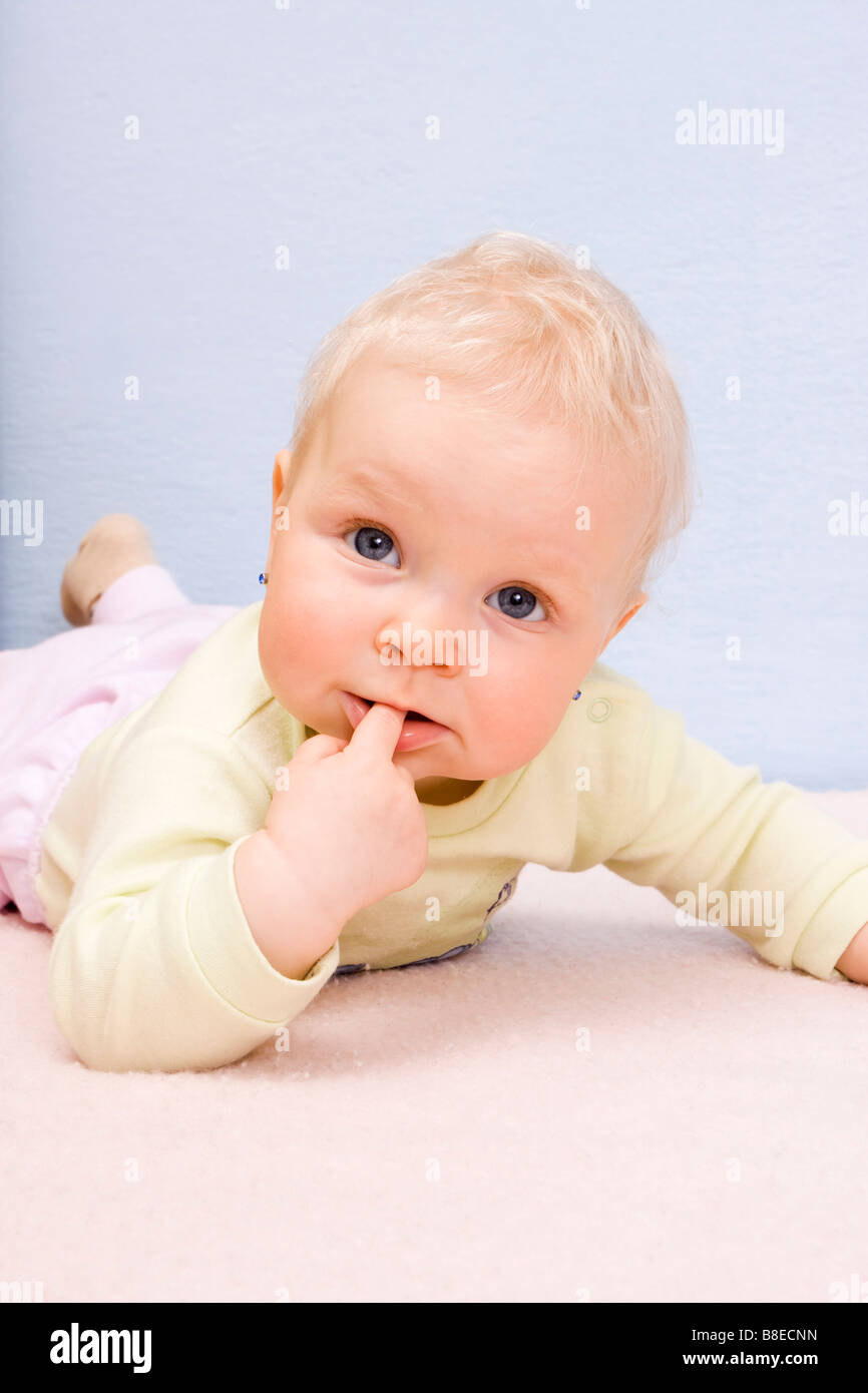 Lying baby girl 9 months old indoor Stock Photo Alamy