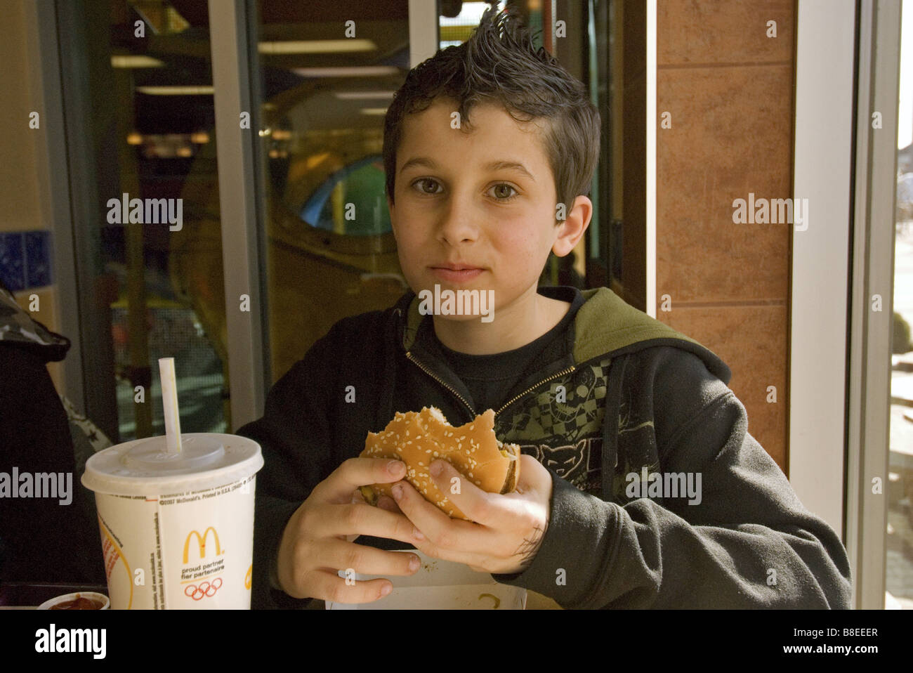 Boy eating McDonalds hamburger Stock Photo Alamy