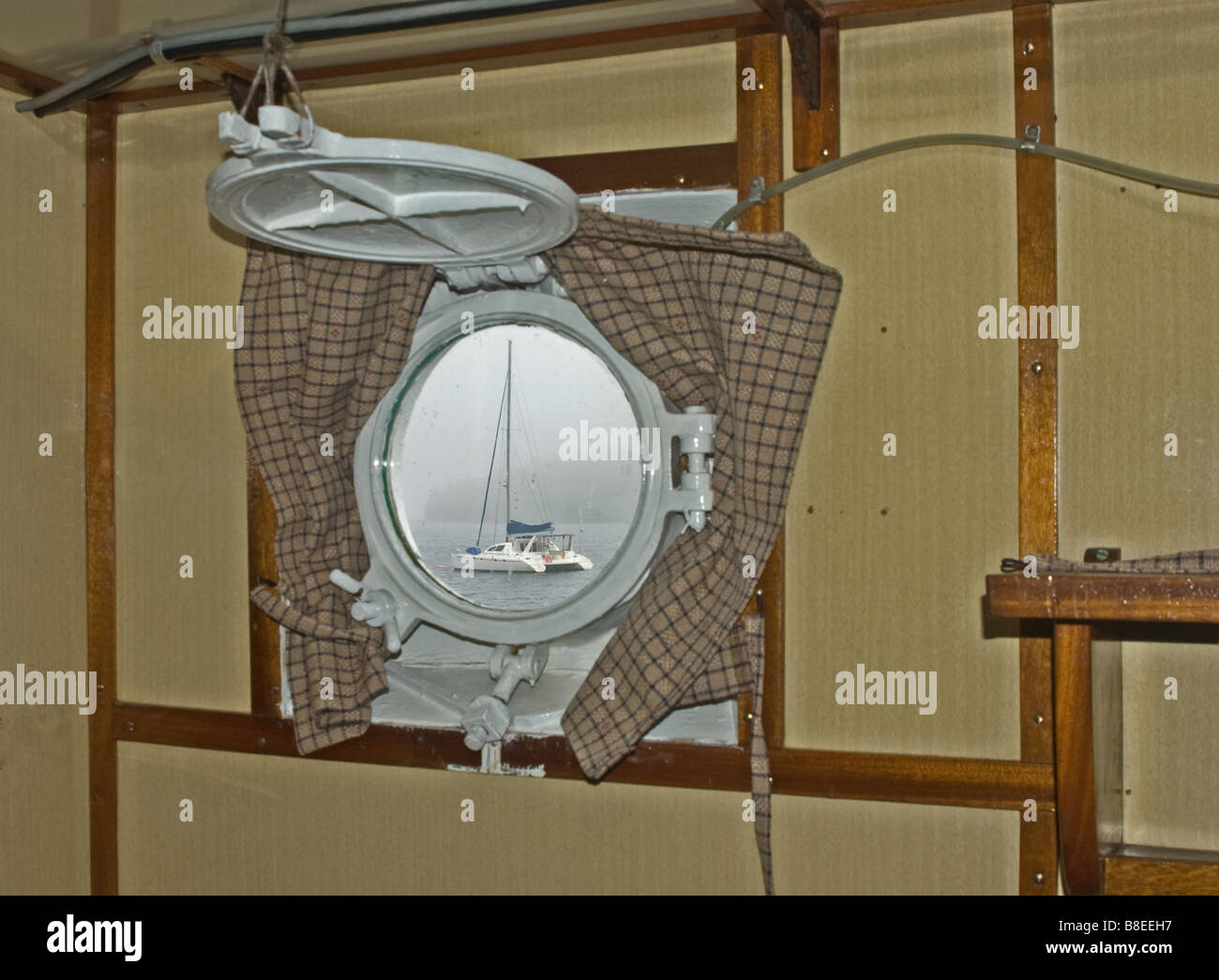 Catamaran Sail Boat through porthole window Stock Photo