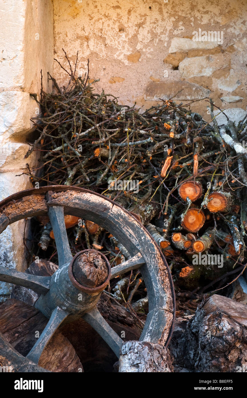 Broken wooden wheel and stack of firewood, France. Stock Photo