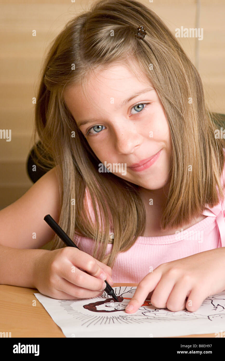 little girl in sunday school coloring a picture of Jesus Stock Photo